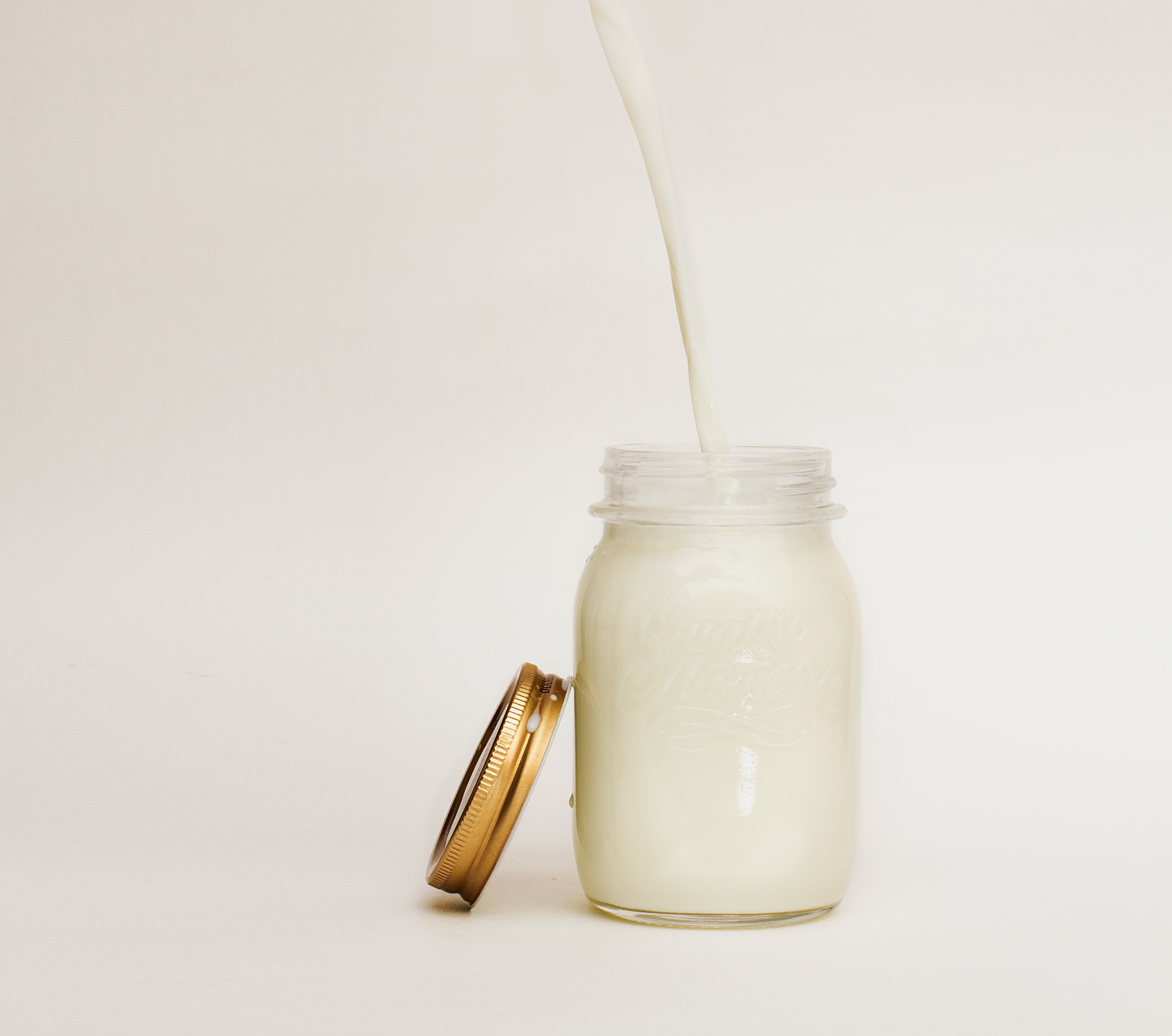 Milk pouring into mason jar